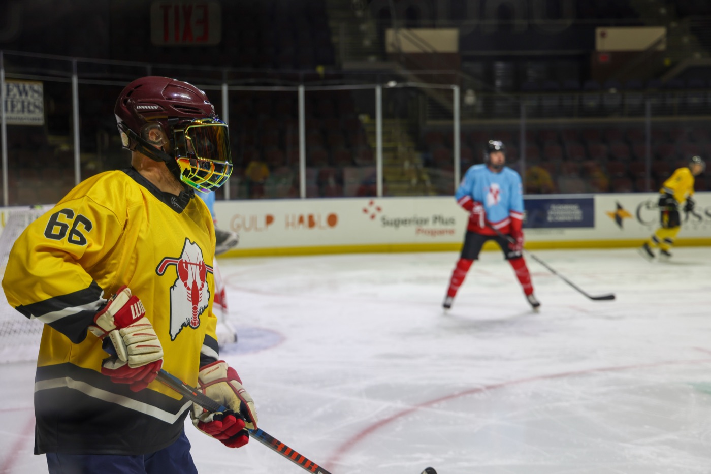 A skater leaning on the boards between shifts
